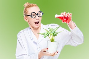 A crazy chemist watering a flower with a chemical substance from